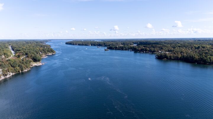 Wide river channel from high above, forest on both banks
