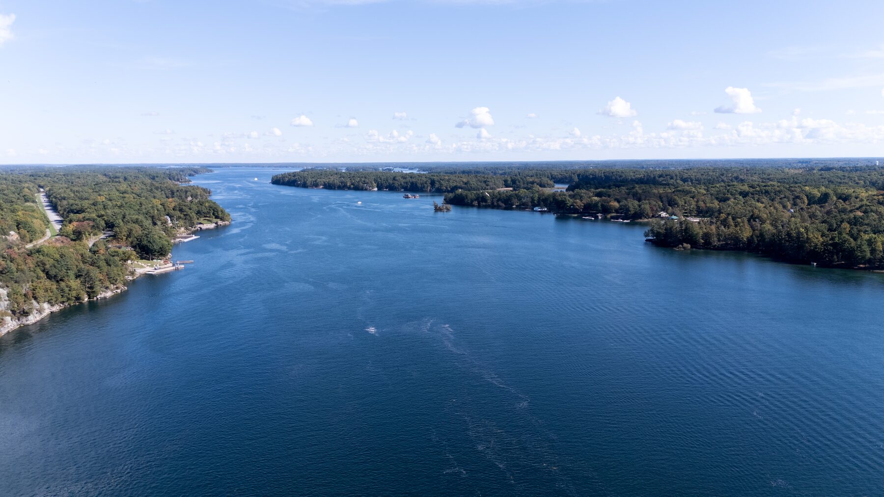Wide river channel from high above, forest on both banks
