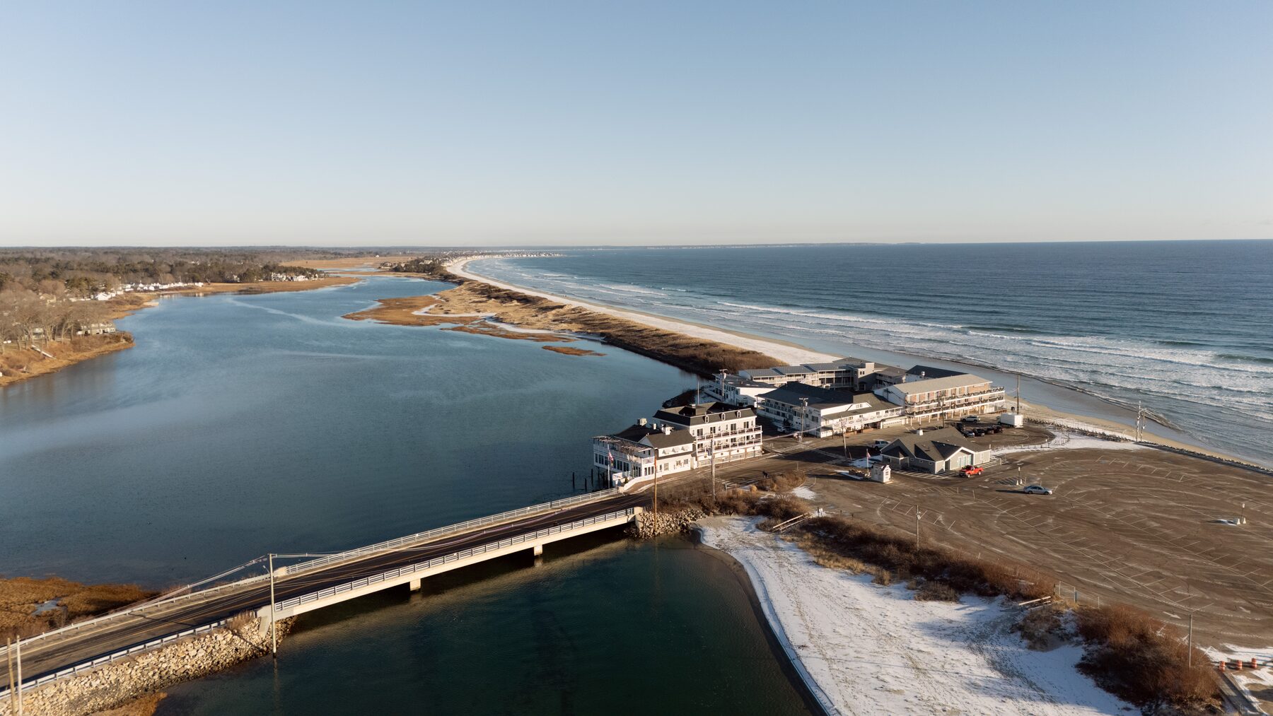 Long beach and river mouth with a road bridge, in winter